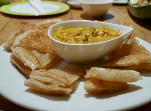 Indian pancake served with chicken curry
