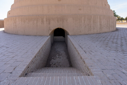 Under a brilliant corona, the ancient Yakhchal is majestic and teeming with tourists. Yazd, Iran.