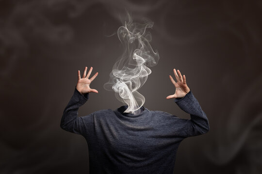 Woman head going up in smoke showing burnout syndrome or mental illness. Creative concept of overheating head or burning out