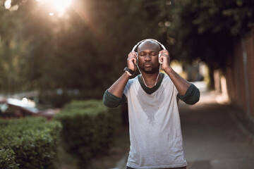 Man with headphones resting after street run