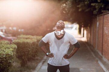 Man with headphones resting after street run