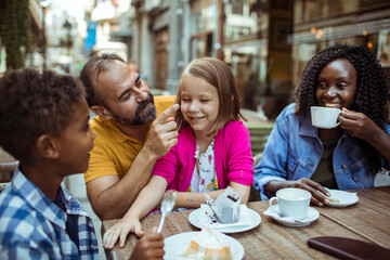 Happy multiethnic family enjoying time at a cafe together