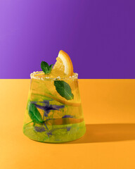 Fresh summer cocktail with orange and mint on a bright background