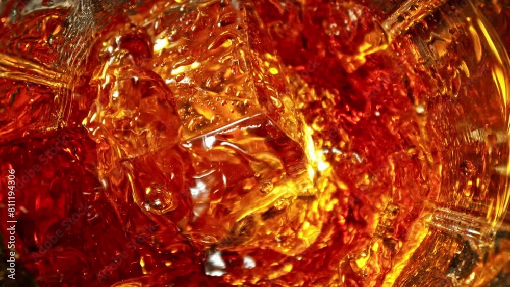 Poster super slow motion of falling ice cube into cola drink. filmed on high speed cinema camera, 1000 fps,