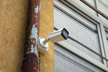 Camera on building with mesh windows