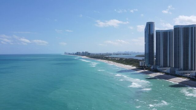 Aerial view of seafront urban buildings and Haulover Beach in Sunny Isles Beach city, Florida, USA