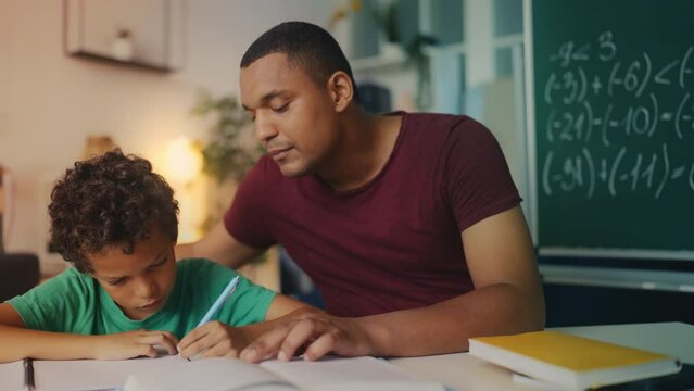 Little boy solves math equations with dad, home education, parental guidance