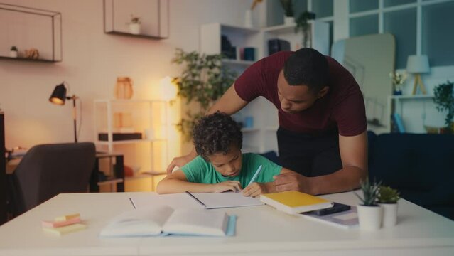 Father scolds his son during homework, too much academic pressure on a child
