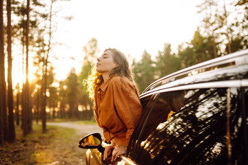 Happy woman enjoy in road trip in car. Summer trip. Lifestyle, travel, tourism, nature, active life.