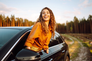 Happy woman enjoy in road trip in car. Summer trip. Lifestyle, travel, tourism, nature, active life.