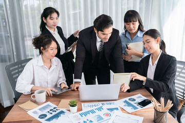 Diverse group of business analyst team analyzing financial data report paper on office table. Chart...