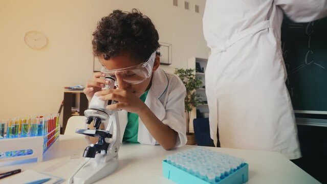 Cool dad and boy play as lab scientists, making chemical research fun for kids