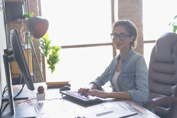 Portrait of young girl it specialist type pc keyboard loft interior business center indoors
