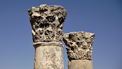 stone capitals in columns against the sky