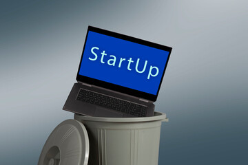 Trashcan with green screen laptop. Failed startup concept