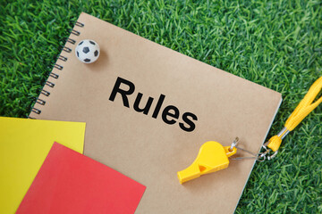 Football soccer rules book and referee equipment; soccer whistle and cards 