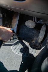 Obraz premium wash worker washes a car, vacuums the interior of the car. Dry cleaning and car detailing. Washing vacuum cleaner. Car interior care.