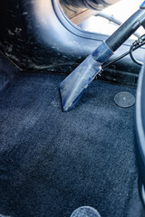 wash worker washes a car, vacuums the interior of the car. Dry cleaning and car detailing. Washing...