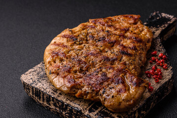 Delicious juicy pork steak with salt, spices and herbs