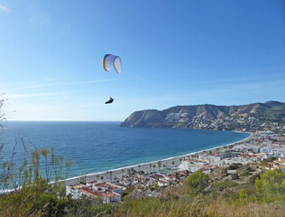 Paragliding above La Herradura beach in Andalucia, Spain	