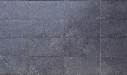 Dark gray horizontal stone tiles for ventilated facade cladding. Background and texture