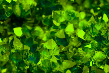 Green crystal mineral stone. Gems. Mineral crystals in the natural environment. Texture of precious and semiprecious stones. Seamless background with copy space colored shiny surface of precious stone