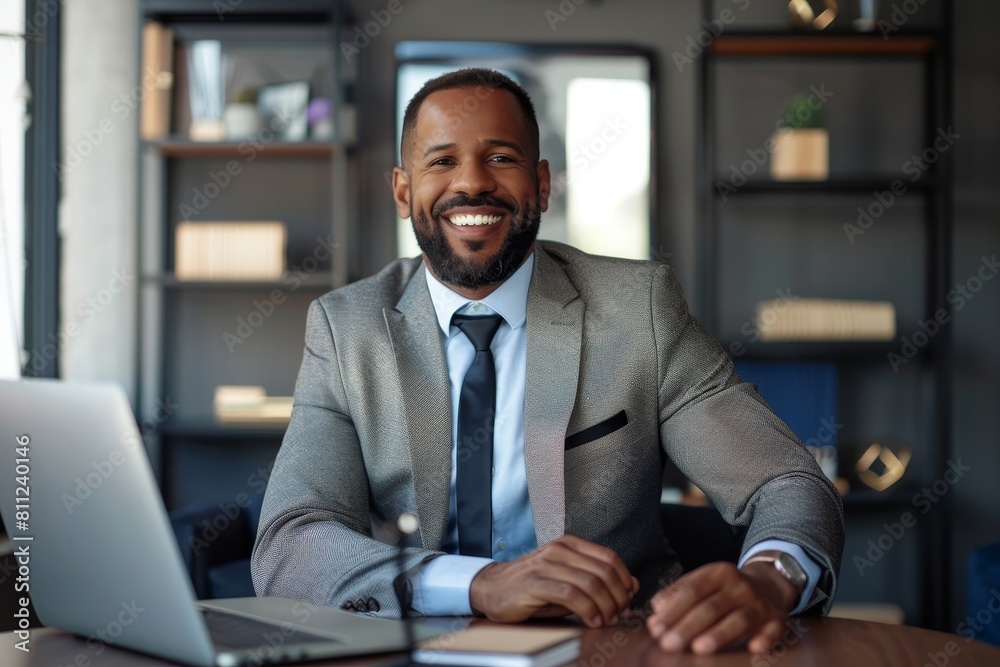 Sticker A man in a suit sits at a table with a laptop open in front of him, engaged in a video call discussing company matters, A high-powered CEO on a video call discussing company growth