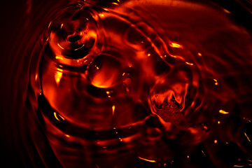 Metallic red water surface Soft waves and air bubbles in the water.