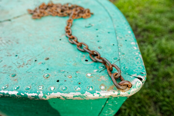 Rusty metal chain on a metal surface aquamarine color. Chain for anchoring. Boat mooring chain	