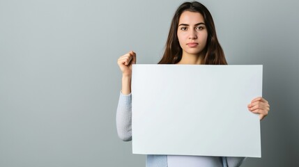 Fototapeta premium A young female holding an empty message board in a voting season