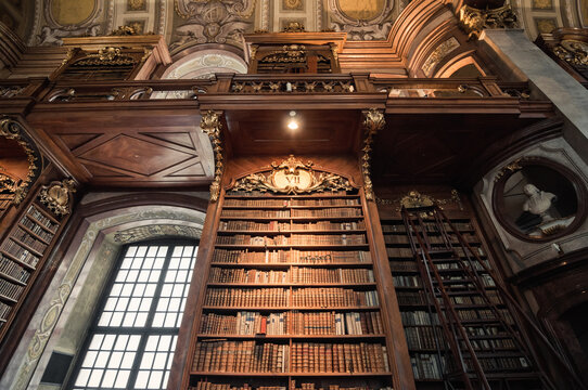 Book shelves in Austrian National Library. Baroque-styled library interior if Prunksaal - hall in building in Hofburg palatial complex. Vienna, Austria - June 30, 2013.