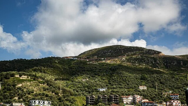 Beautiful view with a sunny summer day and blue sky with Simpsons clouds from a balcony situated in the 9th floor of a residential house in Vlore, Albania
