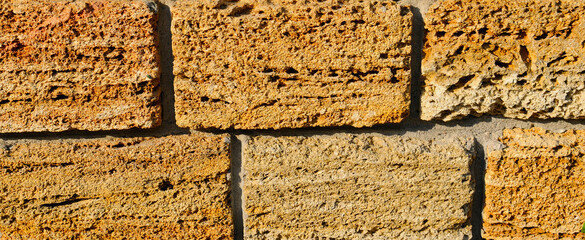 Ashlar stone, wall texture background. Wide photo.
