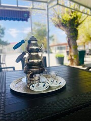 Turkish Tea Time: Traditional Teapot and Glasses in Serene Setting