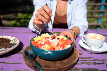 Fruit bowl with papaya, watermelon, melon with natural yogurt and granola. Vegetarian food.