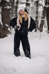 Funny teenage girl posing in the woods in winter.