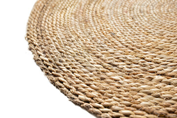 Fototapeta premium Close-up of a woven rattan place mat with natural beige tones
