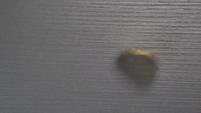 Bitcoin gold coin spin on a black table.
