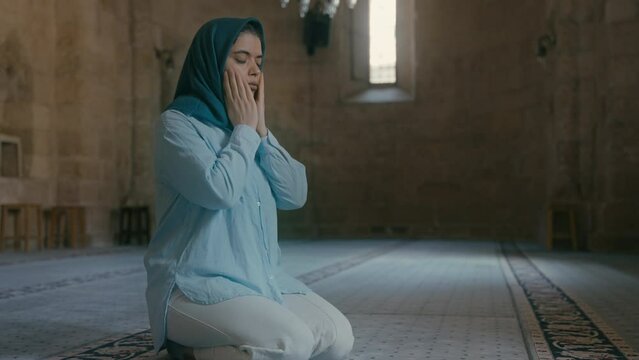 Muslim woman praying in the mosque