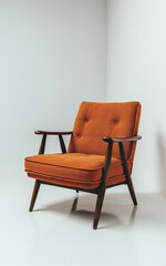 A comfortable orange chair with solid wooden legs and armrests, displayed on a white backdrop.
