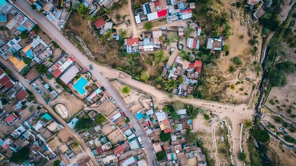 An overhead photo of a country border with poverty on one side the border and a wealthy neighborhood on the other side.