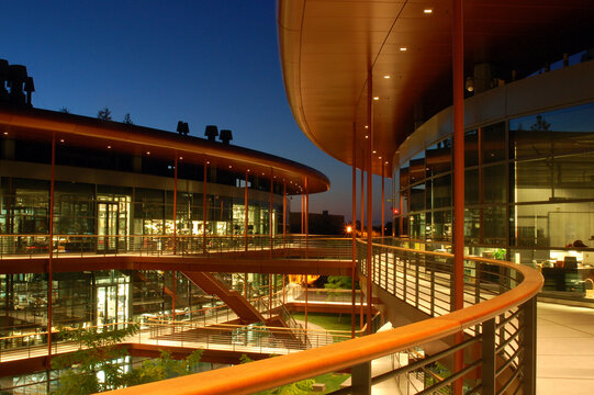 The modern James Clark Center is designed with curving balconies and terraces on the campus of Stanford University at night