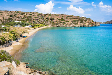 Idyllic view of sandy beach and catamaran boat in sea bay near Chrysopigi monastery, Sifnos island,...