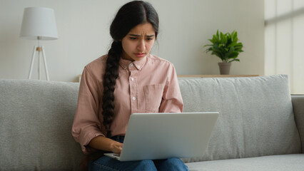 Stressed arabian woman businesswoman student freelancer reading bad news looking at laptop receive...