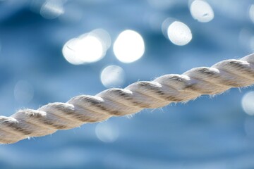 Rope for the boat on the sea with sparkling background
