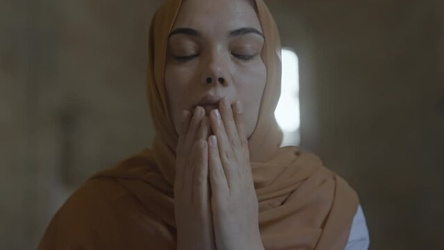 Muslim woman praying in the mosque