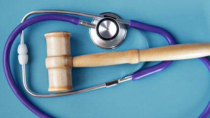 Close-up of a judge's gavel and stethoscope. The concept of the intersection of law and medicine.