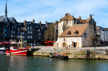 Harbor of Honfleur with the old pier, the Lieutenance house and 2 fishing boats, Normandy, France