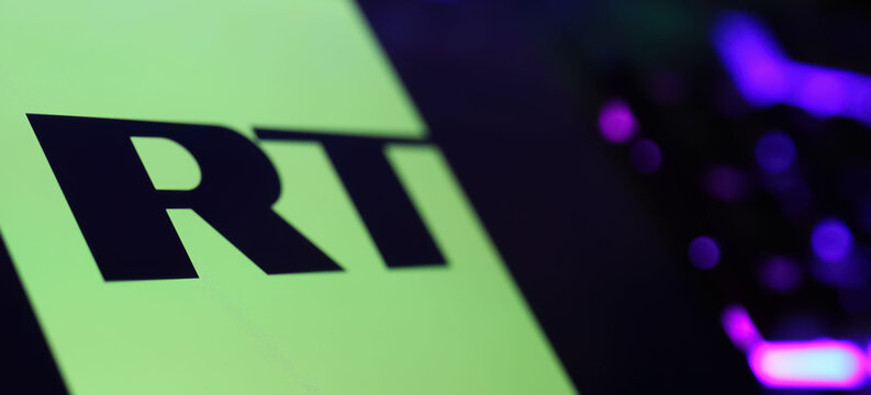 Viersen, Germany - May 9. 2024: Smartphone with logo lettering of Russia Today RT news television network  on computer keyboard