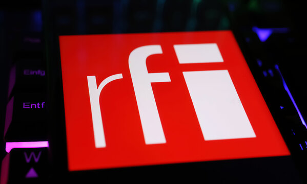 Viersen, Germany - May 9. 2024: Smartphone with logo lettering of Radio France international RFI news radio channel on computer keyboard